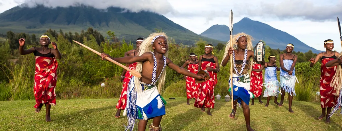 Intore dancers performing below the Virunga volcanoes in Rwanda