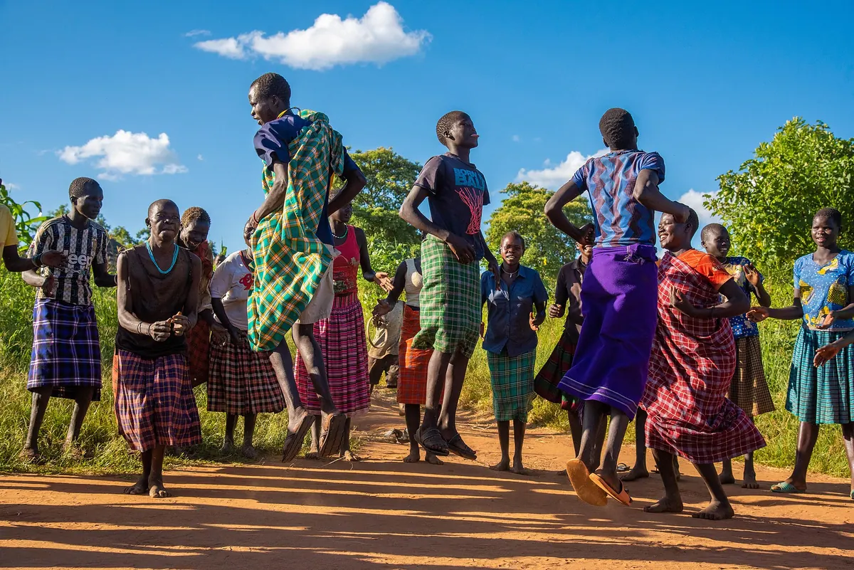 Karamojong men and women performing a traditional jumping dance